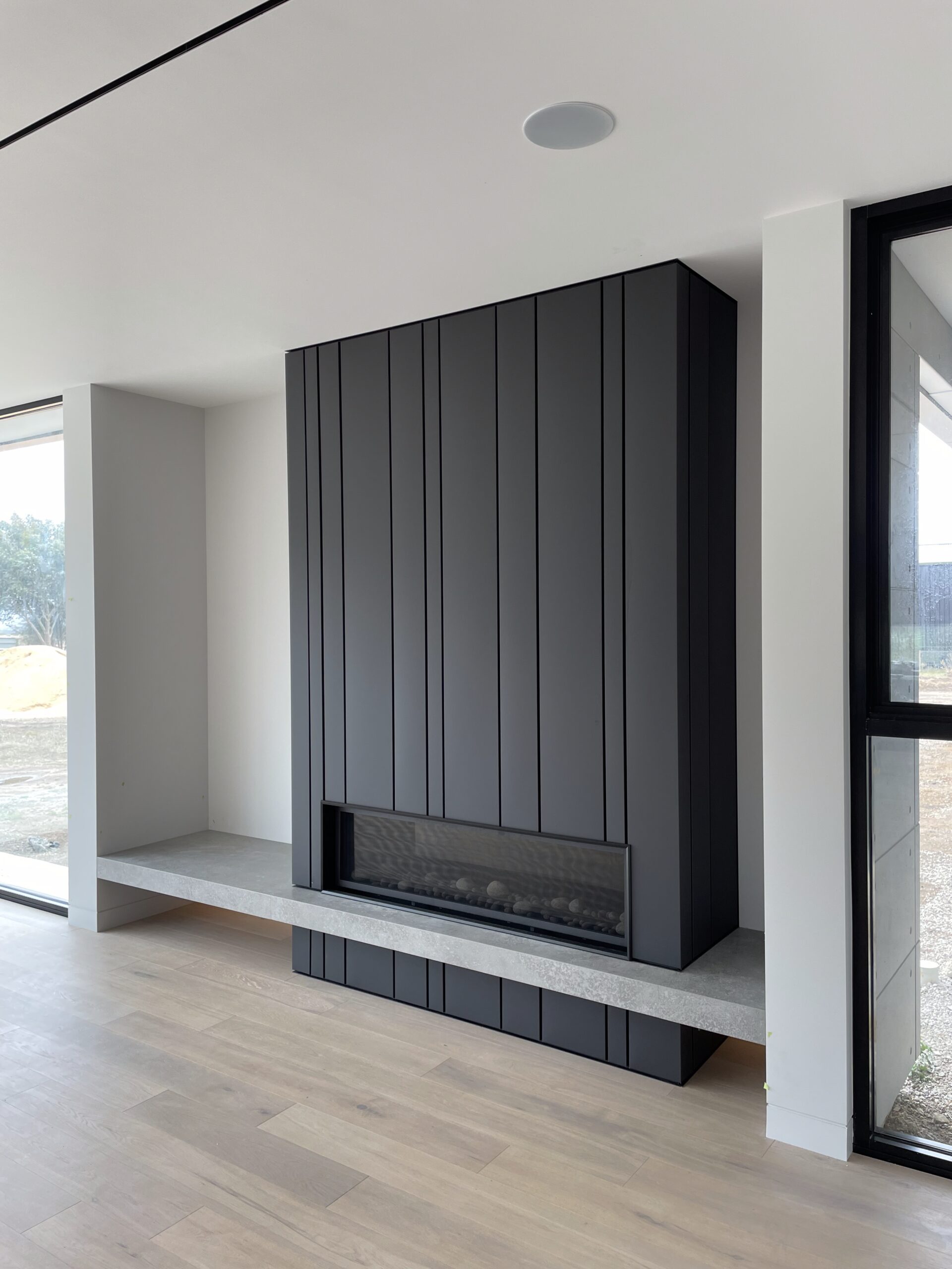 Colorbond Matt Monument Random Interlocking standing seam panels used for Fireplace surround