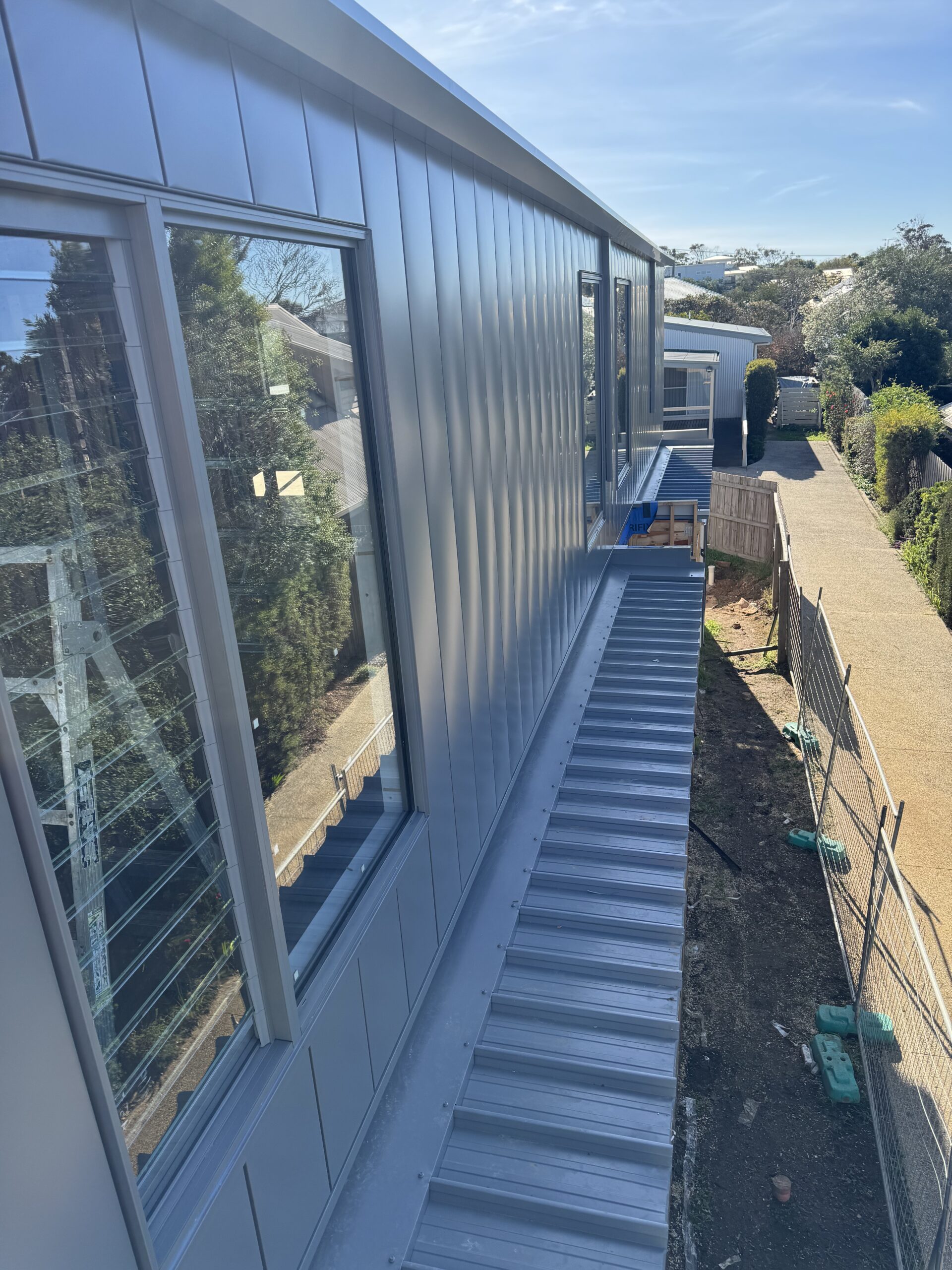 Architectural interlocking wall cladding in Colorbond Wallaby on a modern coastal home in Torquay Victoria